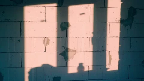 The evening setting sun falls through the window onto the wall of aerated Stock Footage 233709289