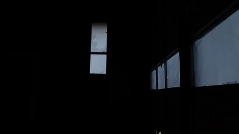 Evening shot, looking out doorway at trash pile, pans 180 to inside empty garage Stock Footage 95111176
