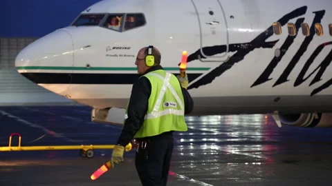 Evening Shot of Ramp Worker and Glowing Traffic Safety Baton (Part 1) Stock Footage 219373775