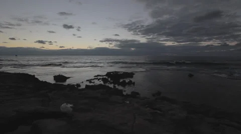 Evening shot of small waves on a rocky shoreline, with sunset Stock Footage 34125505