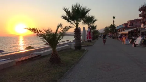 Evening silhouettes against the declining sun at the after pandemic beach 2 Stock Footage 136866103