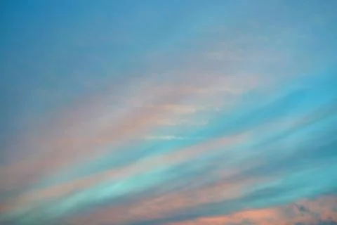 In the evening sky Cirrus clouds are arranged in strips diagonally. Stock Photos