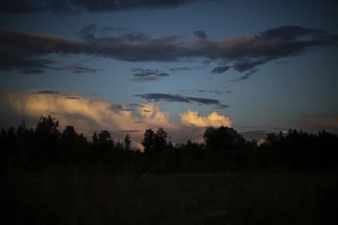Evening sky. Clouds over the black forest. It's getting dark outside. Stock Photos