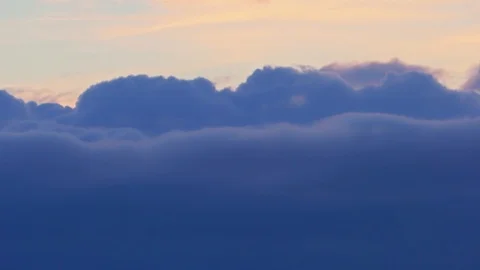 The evening sky, dark blue puffy fluffy clouds quickly rush past. Time lapse 4K Stock Footage 106016380