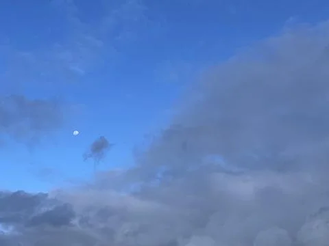 Evening Sky with Dark Clouds and Half Moon Stock Photos