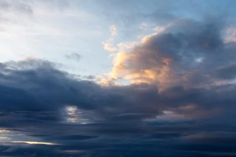 Evening sky with dramatic clouds lit by fading sun Stock Photos