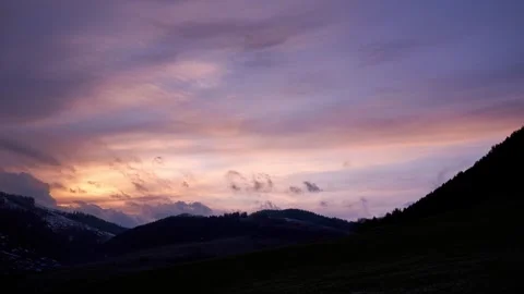 The evening sky is dramatic with clouds over hills and villages Stock Footage 277385417