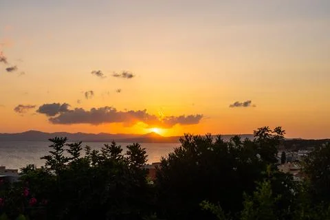 Evening sky with dramatic clouds over the sea. Dramatic sunset over the sea. Stock Photos
