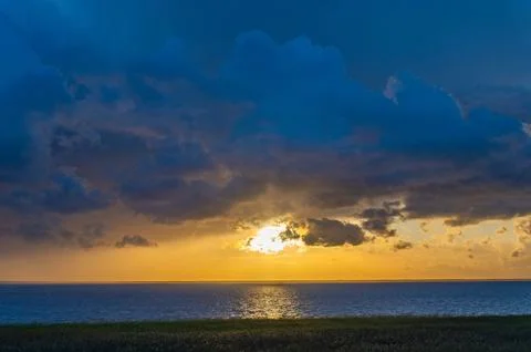 Evening Sky with Dramatic Clouds Over the Lake. Dramatic Sunset Over the La.. Stock Photos