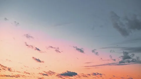 An evening sky filled with clouds as colors shift at sunset. The scene captures Stock Footage 345874544