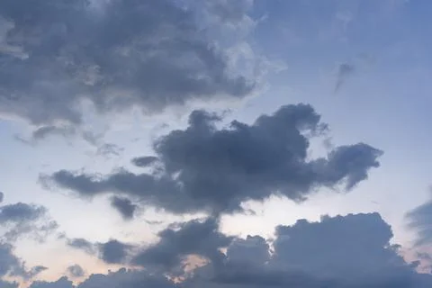 Evening sky with fluffy rain cloud in soft blurred style. Stock Photos