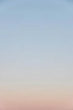 Evening sky gradient with clear horizon, vertical desaturated photo Stock Photos