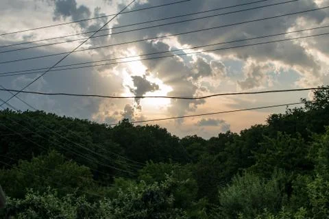 Evening sky over the forest. the clouds have the fom of the dancing angel Stock Photos
