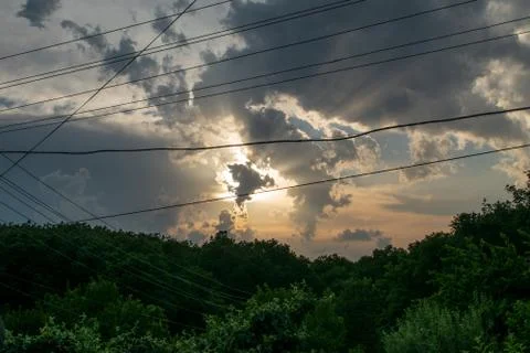 Evening sky over the forest. the clouds have the fom of the dancing angel Stock Photos