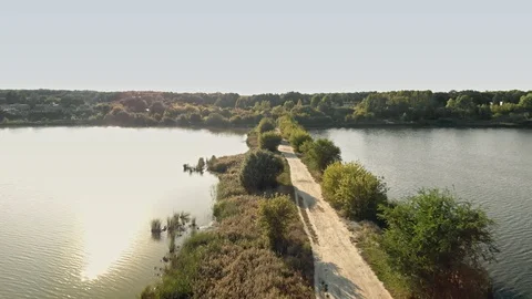 Evening sky over a thin road line in the middle of an artificial lake Stock Footage 111598739