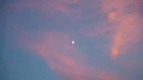 Evening Sky with Pink and Orange Clouds with Half Moon Background Shot Stock Footage 345369829
