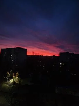 Evening sky with pink clouds over the city Stock Photos