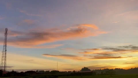 Evening Sky with Soft Clouds and Tower Silhouette Stock Footage 325518340