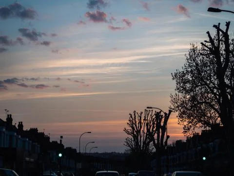 Evening sky, sun setting over London at rush hour Foto stock