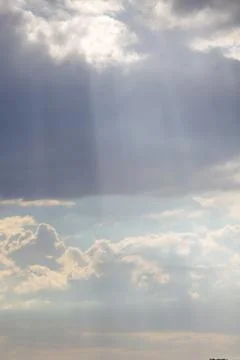 The evening sky in the sunset rays of the sun, massive clouds covering the su Stock Photos