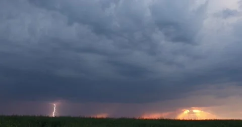 Evening sky thunderstorm lightning over an agricultural field an impending storm Stock Footage 132952961
