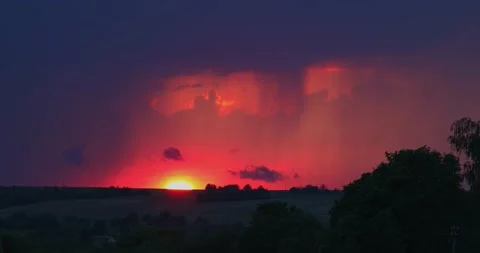 Evening sky thunderstorm lightning over field and village an impending storm Stock Footage 132952975