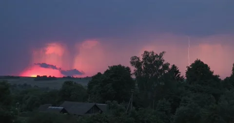 Evening sky thunderstorm lightning over field and village an impending storm Stock Footage 132953002