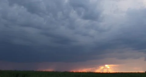 Evening sky thunderstorm lightning over an agricultural field an impending storm Stock Footage 132954457