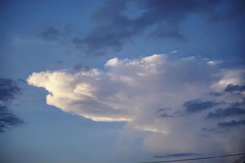 Evening sky view with dramatic large clouds illuminated by natural light Stock Photos