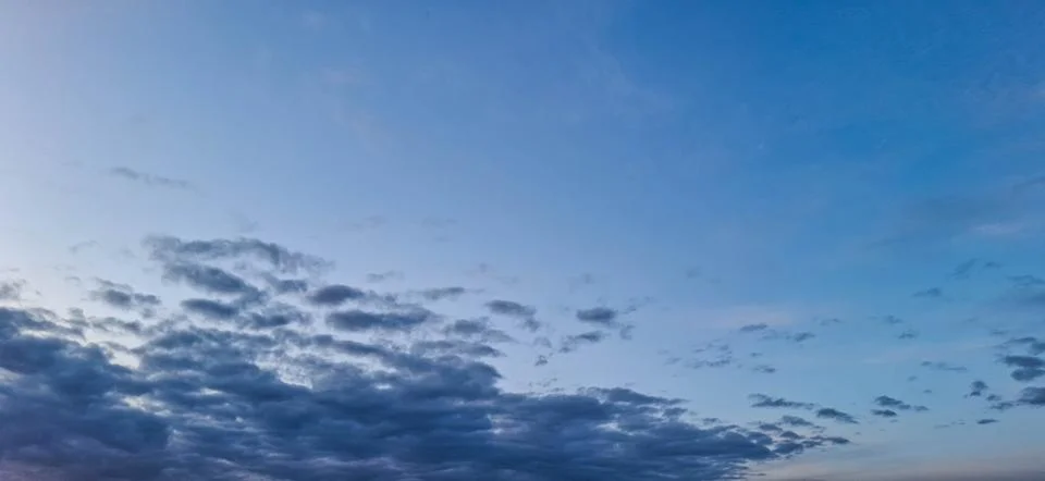Evening sky with yellowish-gray clouds. Stock Photos