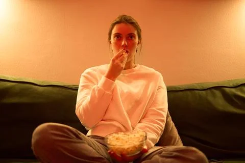 Evening Snack and Screen Time on a Cozy Sofa Stock Photos