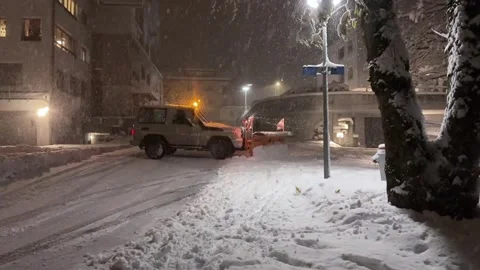 Evening Snowfall in Buochs: Snowplow in Action Stock Footage 293097280