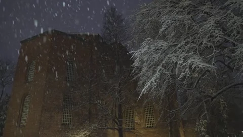 Evening snowfall in a city park and an ancient church in the center of Sofia Stock Footage 328313617