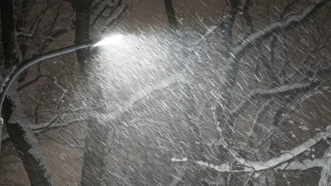 Evening snowstorm, falling snow under the light of a lantern Stock Footage 168704741
