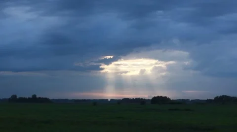 Evening storm sky with sun beams in a summer field Stock Footage 51789979