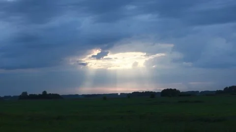 Evening storm sky with sun beams in a summer field Stock Footage 51789989