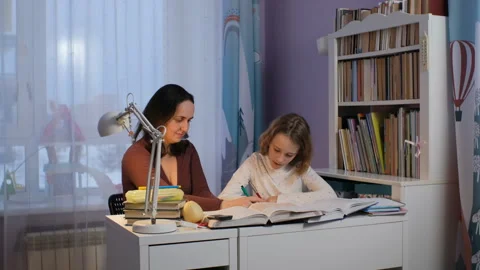 Evening study session between mother and daughter Stock Footage 297103696