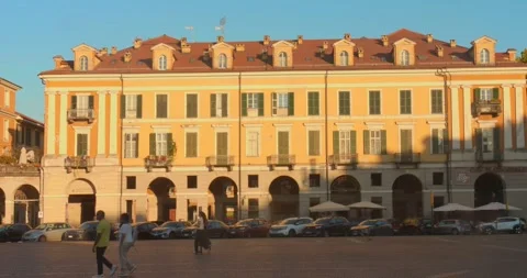 Evening sun on Galimberti Square building facade with pedestrians crossing Vídeos de archivo 347227656