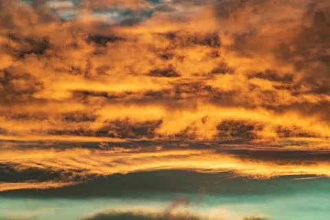 Evening sun hiding behind clouds Stock Photos