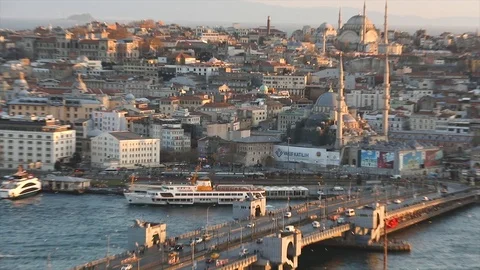 The evening sun illuminates the Blue Mosque and Marche Yeni Cami. A wide frame Stock Footage 114999076