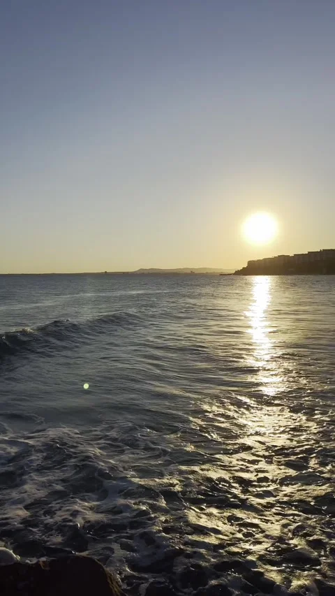 Evening sun reflecting on moving ocean waves Stock Footage 318713841