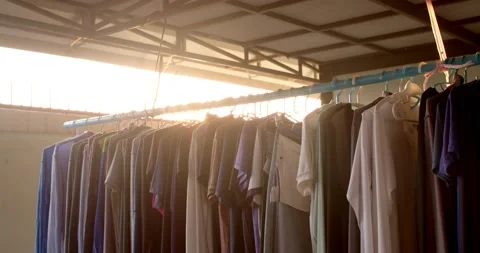 The evening sun shines through the clothesline with a golden yellow glow. Stock Footage 222895079