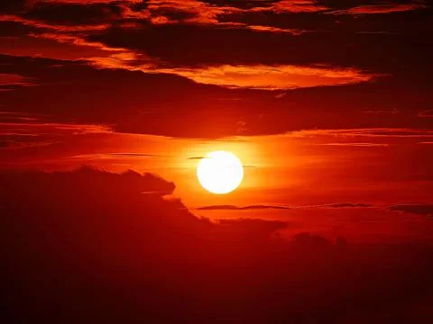 The evening sun in the sky and clouds Stock Photos