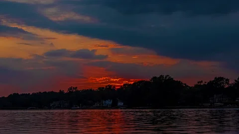Evening Sun Is Slowly Setting Behind The Trees - Time-lapse Video stock 159155178