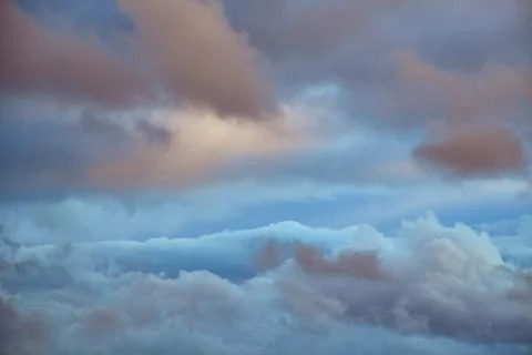 Evening sunlight on cumulus clouds in the sky Stock Photos