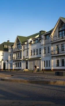 Evening sunlight falls on the facade of the building. The facade of the old.. Stock Photos