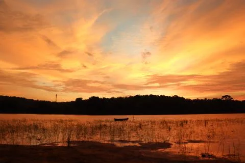 The evening sunlight is reflected in the river below. Stock Photos