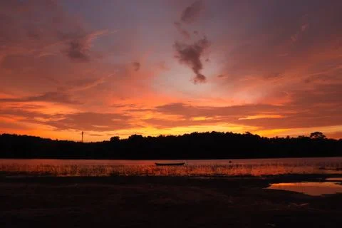The evening sunlight is reflected in the river below. Stock Photos