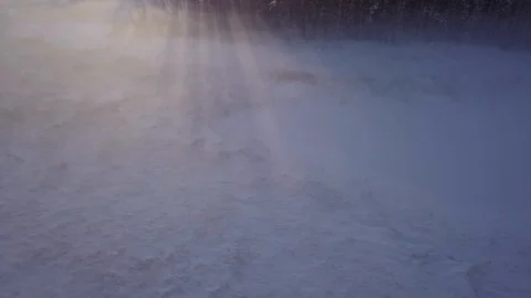 Evening sunrays on fog hovering over frozen lake shore during sunset Stock Footage 105165408