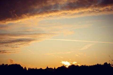 Evening sunset with clouds on the background of the shadows of buildings 스톡 사진